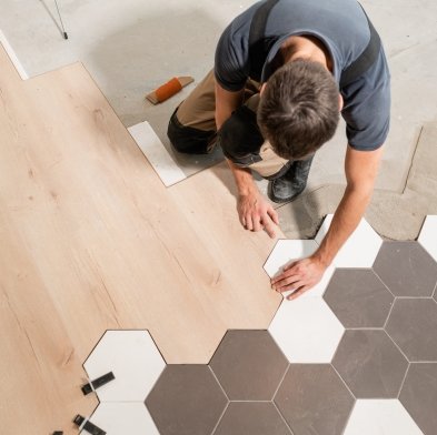 flooring installer combining ceramic and wood flooring in a modern pattern in Huron, SD area